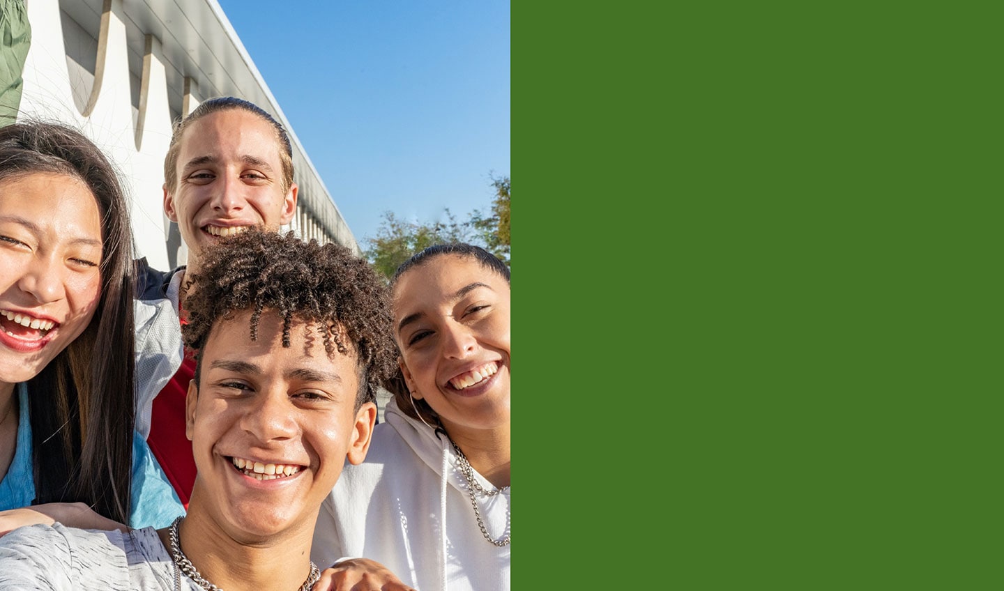 Four students smiling.